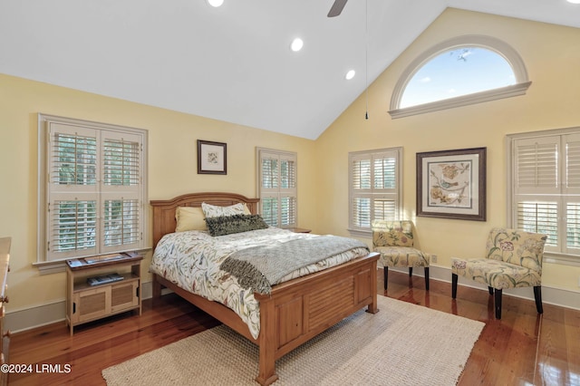 bedroom with dark hardwood / wood-style flooring, high vaulted ceiling, and ceiling fan