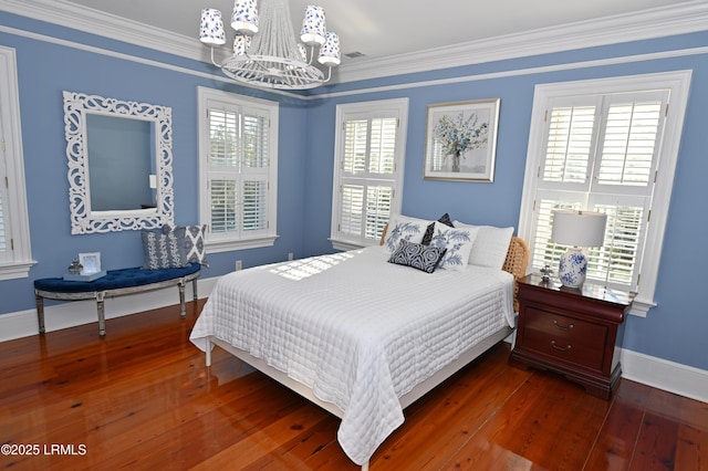 bedroom with a notable chandelier, crown molding, and dark hardwood / wood-style floors