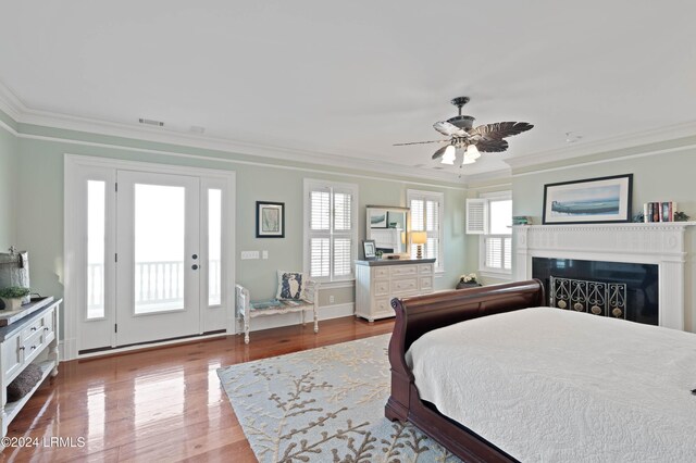 bedroom with hardwood / wood-style flooring, ceiling fan, multiple windows, and access to outside