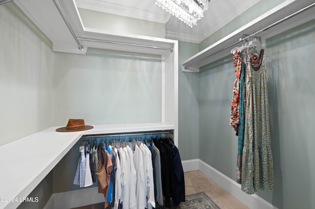 spacious closet with a chandelier