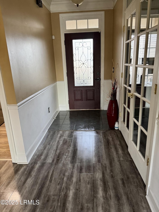 entrance foyer featuring a wainscoted wall, wood finished floors, and ornamental molding