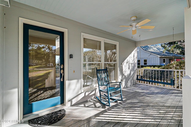 deck with covered porch, visible vents, and a ceiling fan