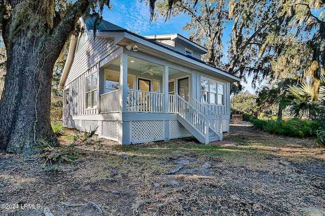 view of front facade with a ceiling fan, covered porch, and metal roof