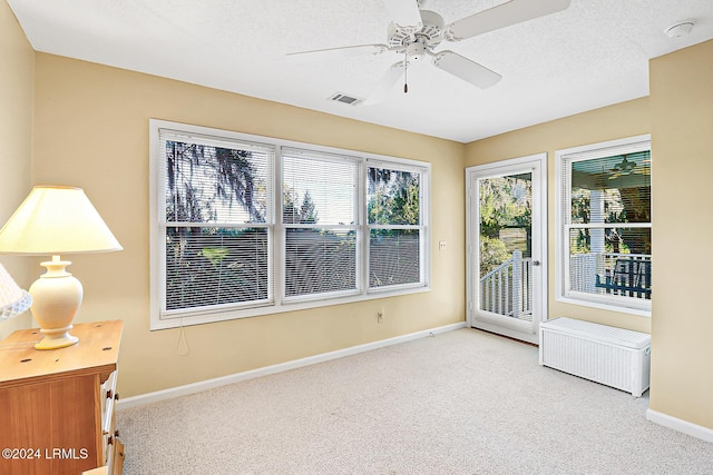 interior space featuring visible vents, ceiling fan, and radiator heating unit