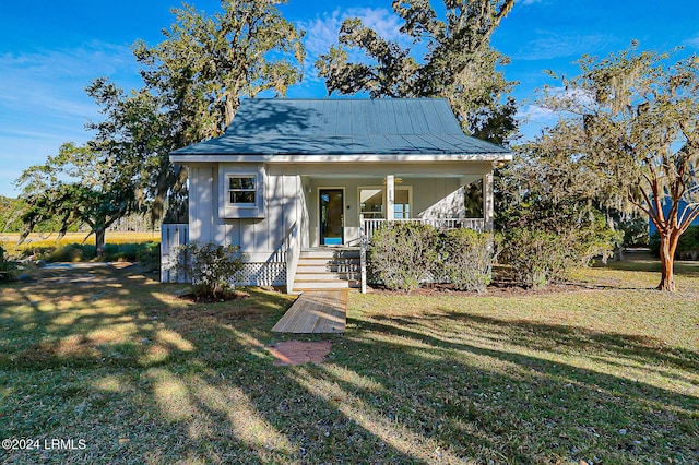 bungalow-style house with a porch, board and batten siding, and a front yard