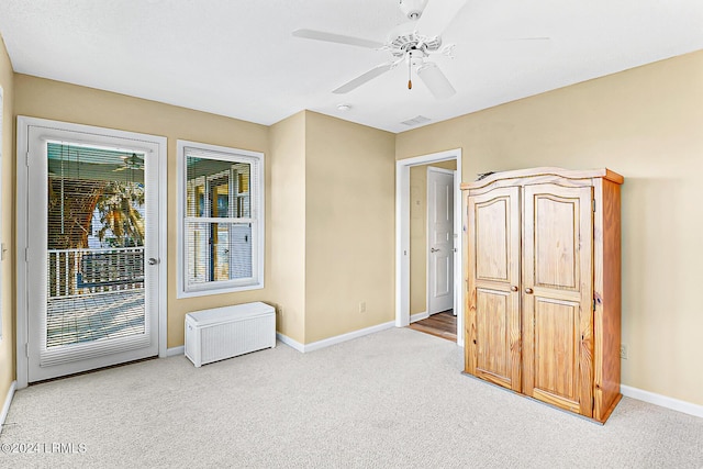 empty room featuring a ceiling fan, carpet flooring, visible vents, and baseboards