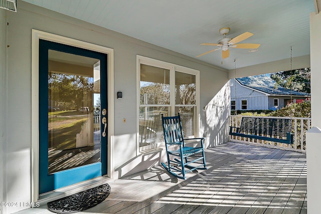 deck with ceiling fan, visible vents, and a porch