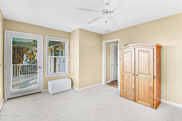 unfurnished room with carpet, visible vents, ceiling fan, and baseboards