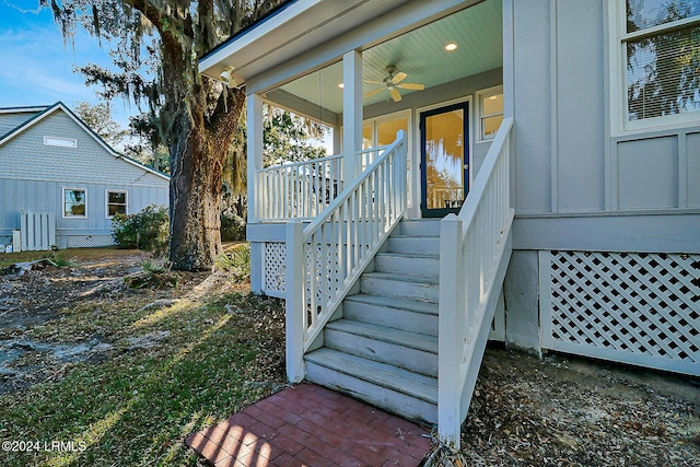 view of exterior entry with a porch and ceiling fan