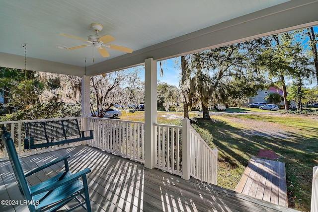 wooden deck featuring covered porch and ceiling fan