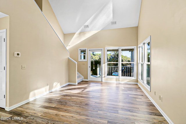 foyer entrance with stairway, wood-type flooring, visible vents, and baseboards