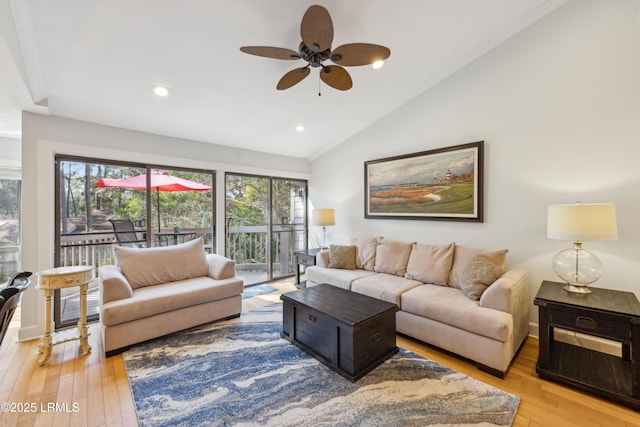 living room with lofted ceiling, ceiling fan, and light hardwood / wood-style flooring