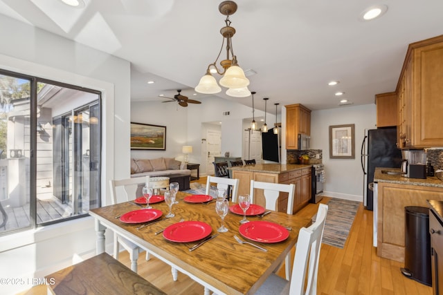 dining room featuring vaulted ceiling, ceiling fan, and light hardwood / wood-style floors