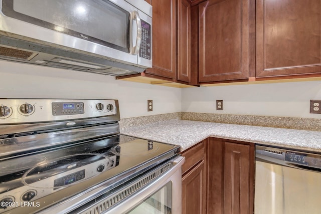 7 Harbison Pl, Beaufort, SC 29906 - kitchen with stainless steel appliances, light countertops, and brown cabinets