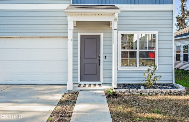 view of exterior entry featuring driveway