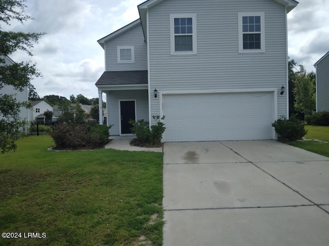 traditional home featuring a garage, driveway, and a front lawn