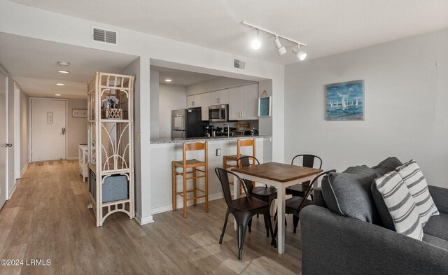 dining space with light hardwood / wood-style floors