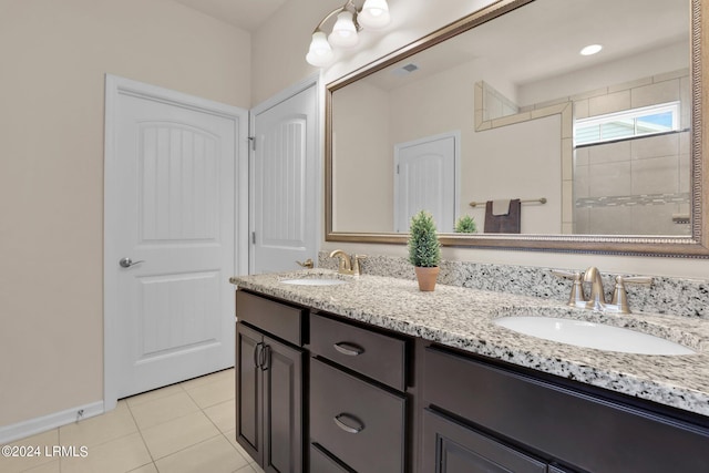 bathroom featuring tile patterned floors, vanity, and a shower