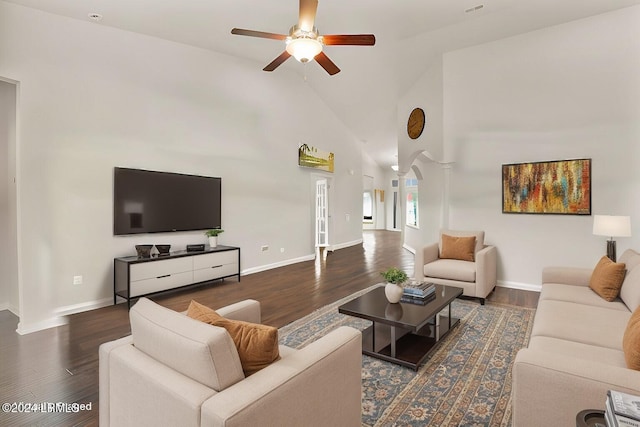 living room featuring ornate columns, ceiling fan, dark wood-type flooring, and high vaulted ceiling