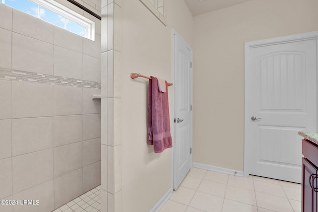 bathroom with vanity, a tile shower, and tile patterned floors