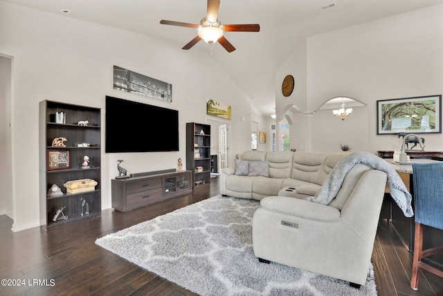 living room featuring dark hardwood / wood-style flooring, high vaulted ceiling, ceiling fan, and ornate columns