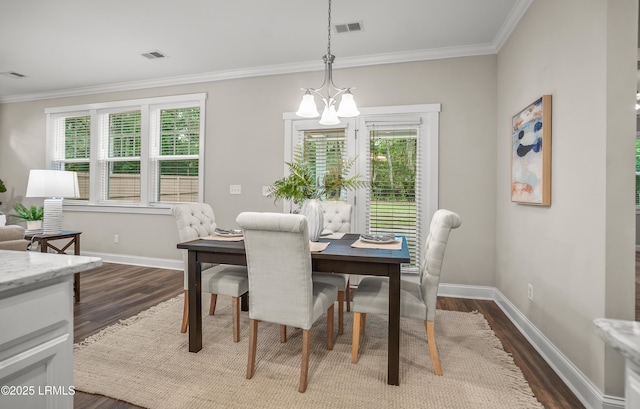 28 Laughing Gull Dr, Beaufort, SC 29907 - dining area featuring a chandelier, dark wood finished floors, plenty of natural light, and ornamental molding