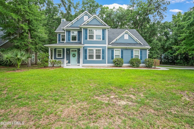28 Laughing Gull Dr, Beaufort, SC 29907 - view of front of home featuring a porch, a front yard, and a chimney