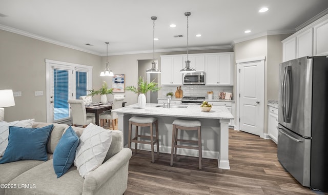 28 Laughing Gull Dr, Beaufort, SC 29907 - kitchen with stainless steel appliances, open floor plan, crown molding, backsplash, and dark wood-type flooring