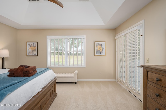 6 River Marsh Ln, Okatie, SC 29909 - bedroom with baseboards, light colored carpet, a tray ceiling, access to exterior, and a ceiling fan