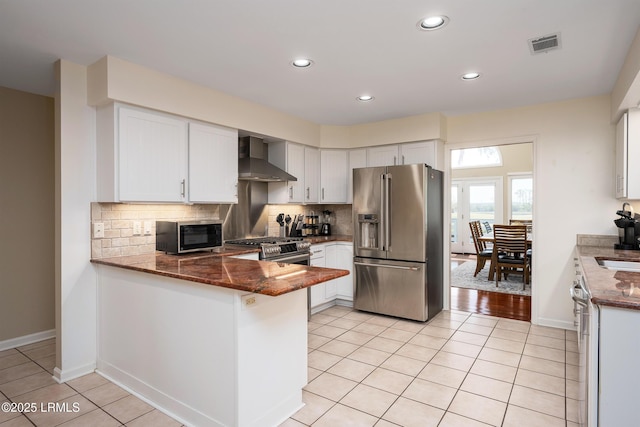 6 River Marsh Ln, Okatie, SC 29909 - kitchen with stainless steel appliances, wall chimney exhaust hood, a peninsula, tasteful backsplash, and recessed lighting