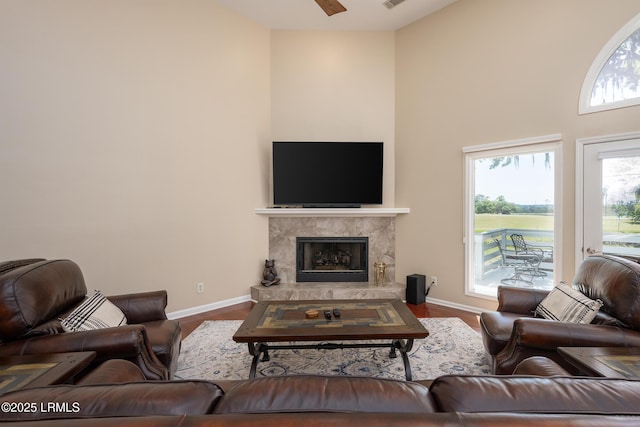 6 River Marsh Ln, Okatie, SC 29909 - living room featuring a high ceiling, baseboards, a premium fireplace, and wood finished floors