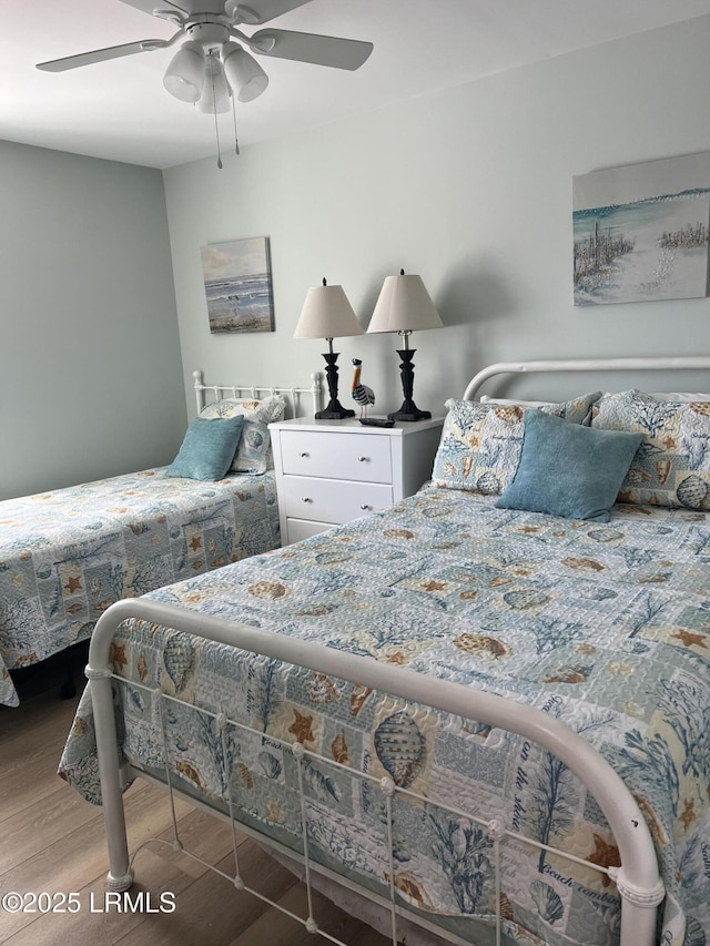 bedroom with wood-type flooring and ceiling fan