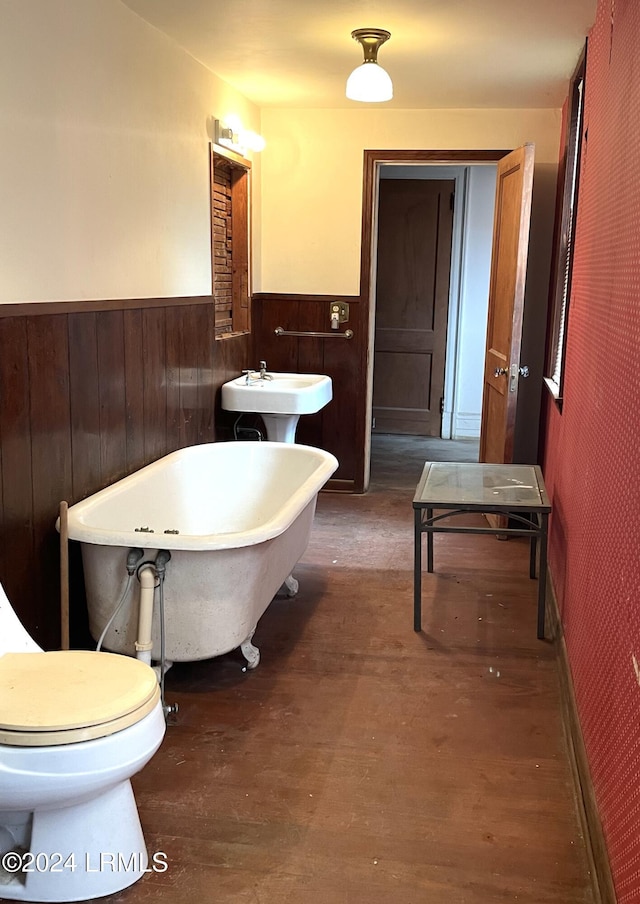 901 7th St W, Fairfax, SC 29827 - bathroom featuring sink, a bathtub, toilet, and wood walls