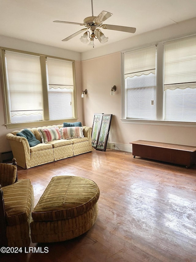901 7th St W, Fairfax, SC 29827 - living room with a baseboard heating unit, ceiling fan, and light wood-type flooring