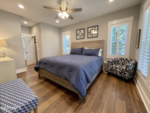 bedroom featuring multiple windows, wood finished floors, and recessed lighting