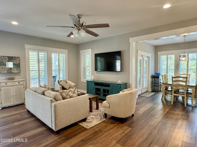 kitchen featuring electric stove, dark wood finished floors, light countertops, white cabinets, and wall chimney range hood