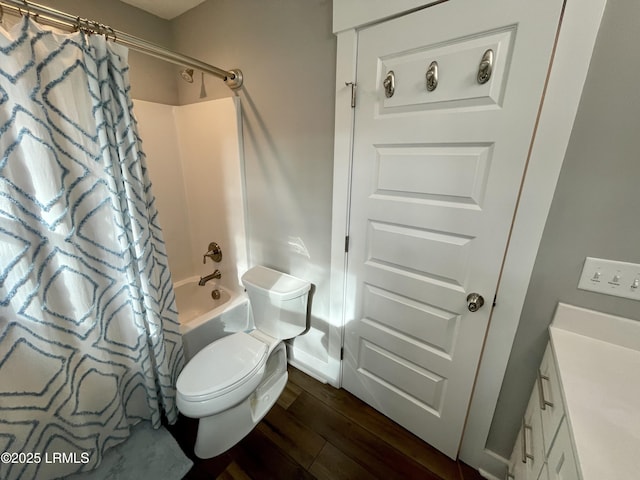 full bath with vanity, wood finished floors, shower / bath combination with curtain, and toilet