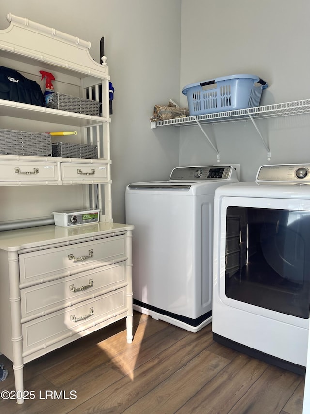 laundry room with laundry area, separate washer and dryer, and dark wood finished floors