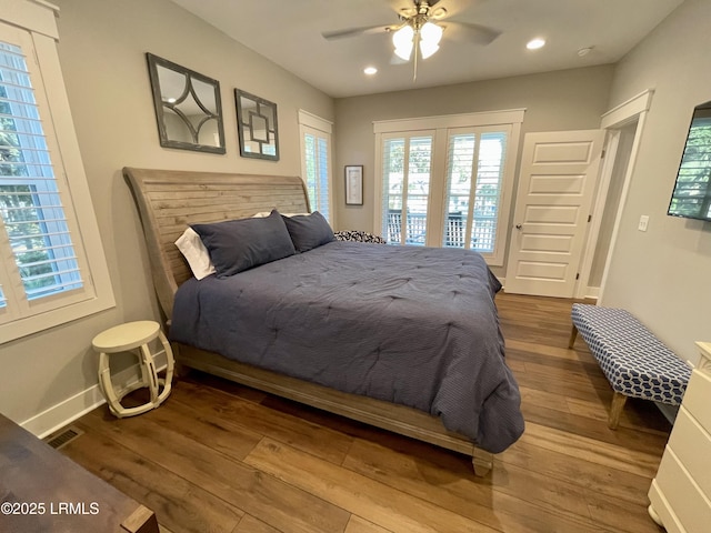 bedroom with baseboards, access to outside, wood finished floors, and recessed lighting