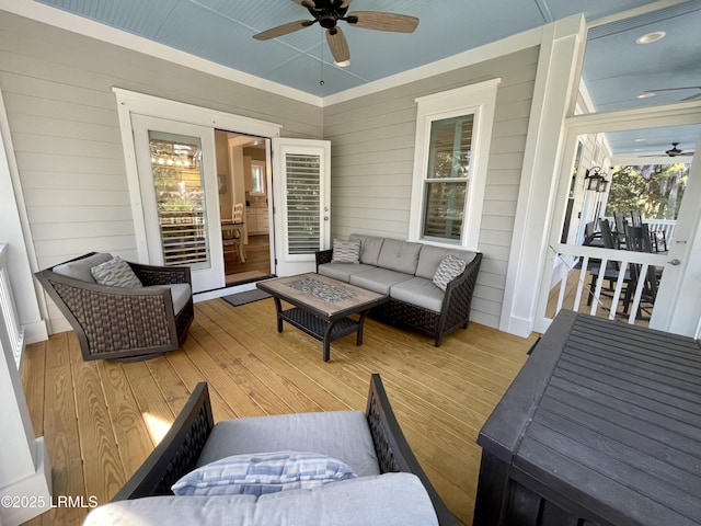 wooden deck featuring ceiling fan and outdoor lounge area