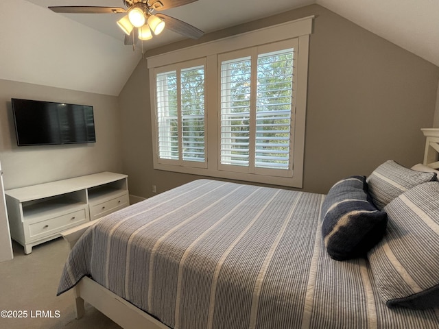 carpeted bedroom featuring vaulted ceiling and ceiling fan