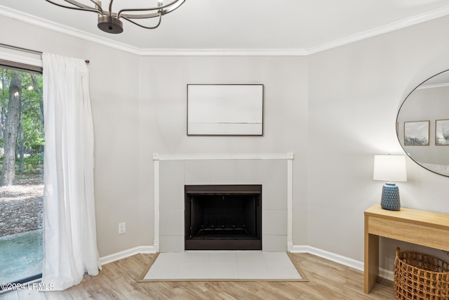 details featuring a tiled fireplace, hardwood / wood-style flooring, and ornamental molding