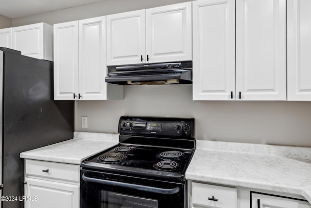 kitchen featuring black appliances and white cabinets