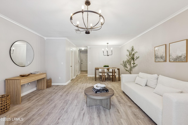 living room with ornamental molding, a notable chandelier, and light hardwood / wood-style floors