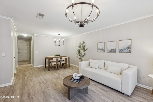 living room featuring ornamental molding, an inviting chandelier, and light hardwood / wood-style flooring