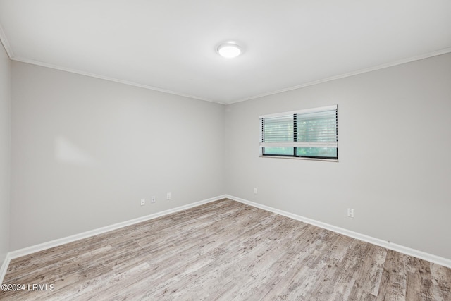 unfurnished room featuring ornamental molding and light hardwood / wood-style floors