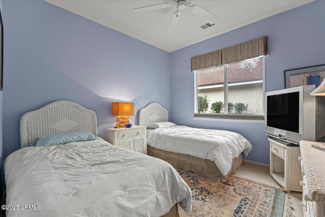 bedroom with baseboards, carpet flooring, visible vents, and a ceiling fan