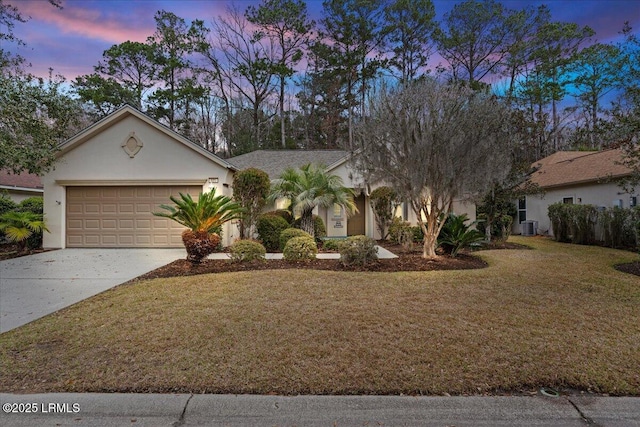 view of front of property featuring stucco siding, concrete driveway, a front yard, a garage, and cooling unit