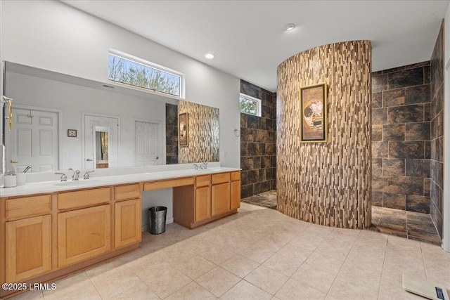 full bath featuring a walk in shower, double vanity, a sink, and recessed lighting