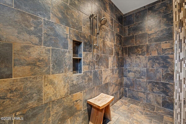 bathroom with tiled shower